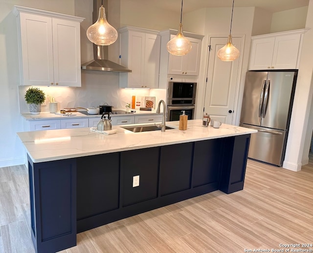 kitchen with hanging light fixtures, stainless steel appliances, and white cabinetry