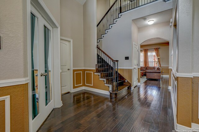 entrance foyer with dark hardwood / wood-style flooring and a high ceiling