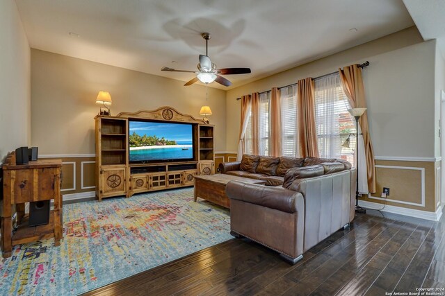 living room featuring ceiling fan and dark hardwood / wood-style flooring