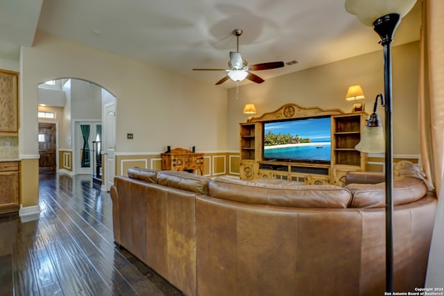 living room with dark hardwood / wood-style flooring and ceiling fan