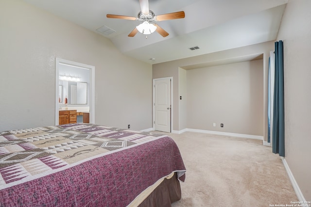 bedroom featuring ceiling fan, ensuite bath, vaulted ceiling, and light carpet