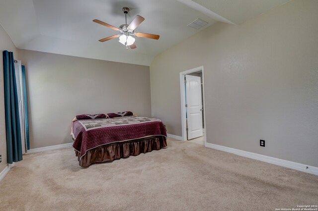 carpeted bedroom with ceiling fan and vaulted ceiling