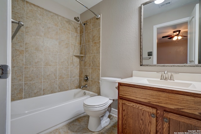 full bathroom featuring tile patterned floors, toilet, tiled shower / bath combo, ceiling fan, and vanity