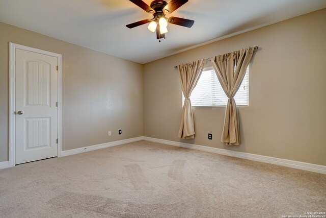 unfurnished room featuring ceiling fan and carpet floors