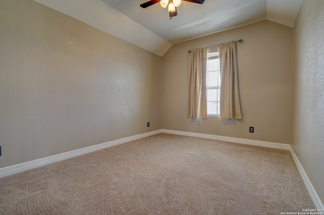 carpeted empty room featuring lofted ceiling and ceiling fan