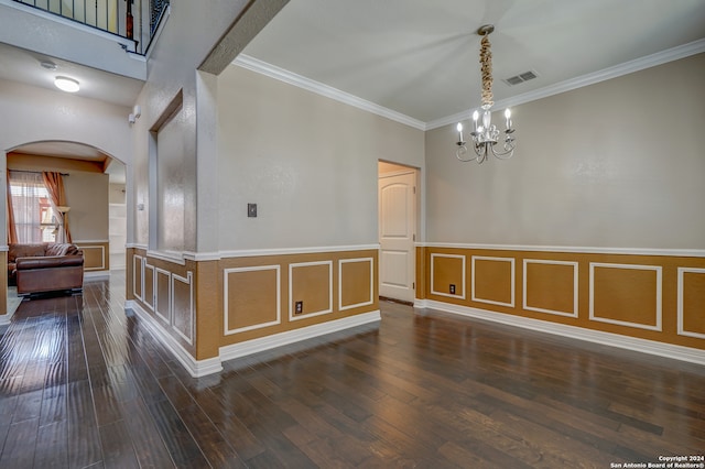 unfurnished room with crown molding, a high ceiling, dark hardwood / wood-style floors, and an inviting chandelier