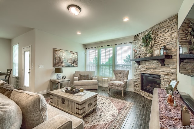 living room with dark wood-type flooring and a fireplace