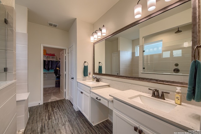 bathroom featuring vanity, hardwood / wood-style floors, and a shower