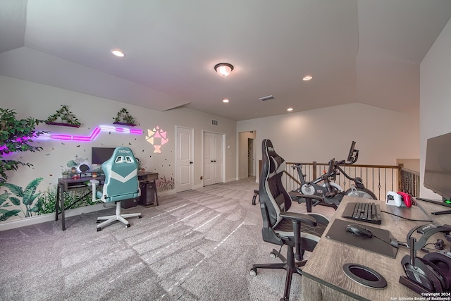 carpeted office space featuring lofted ceiling