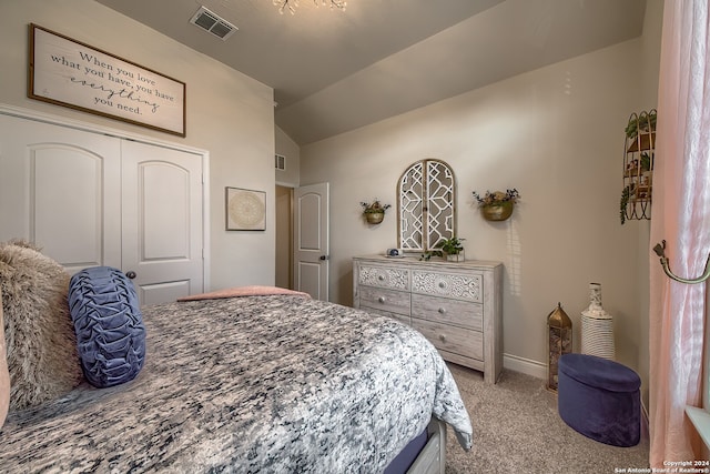 bedroom with lofted ceiling, light colored carpet, and a closet