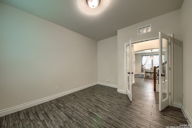 spare room with dark hardwood / wood-style flooring