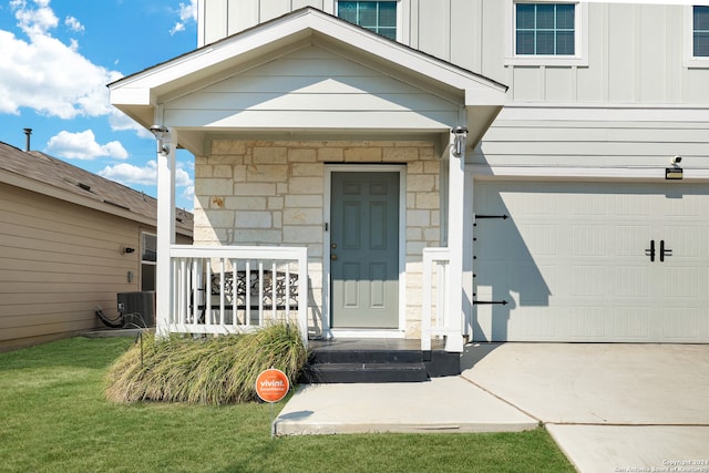 doorway to property with cooling unit and a garage