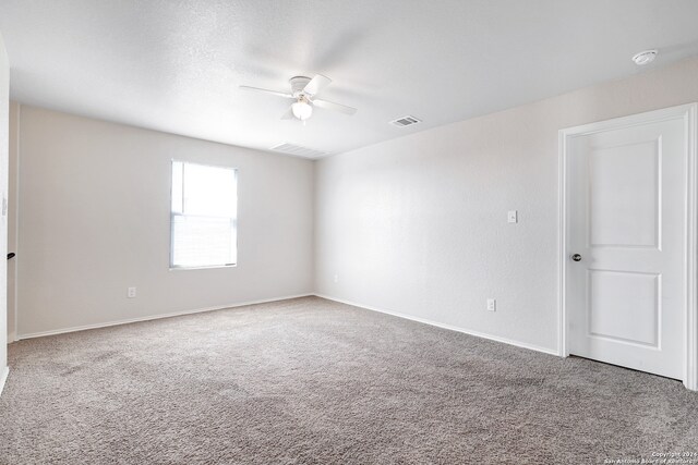 empty room featuring carpet and ceiling fan