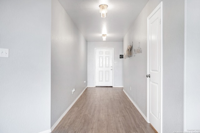 corridor with hardwood / wood-style flooring