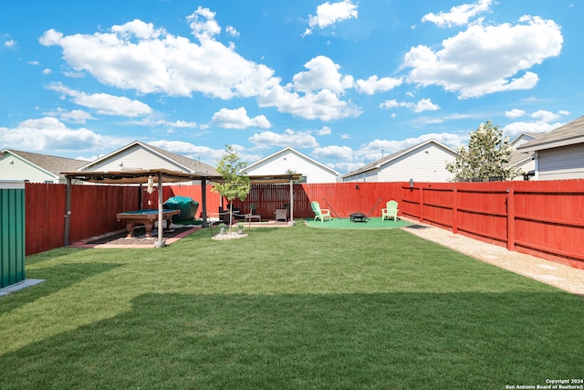 view of yard with a fire pit and a patio area