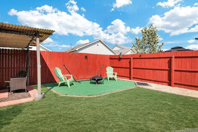 view of yard with an outdoor fire pit