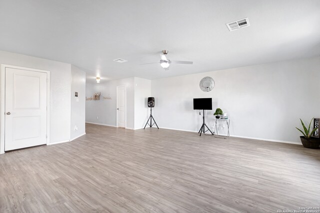 empty room with ceiling fan and light hardwood / wood-style floors