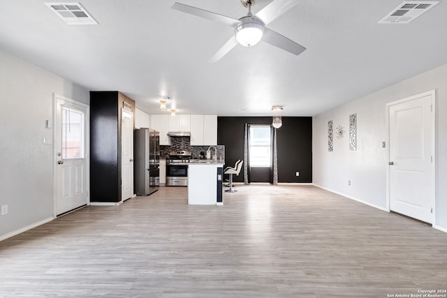 kitchen featuring white cabinetry, stainless steel appliances, and light wood-type flooring