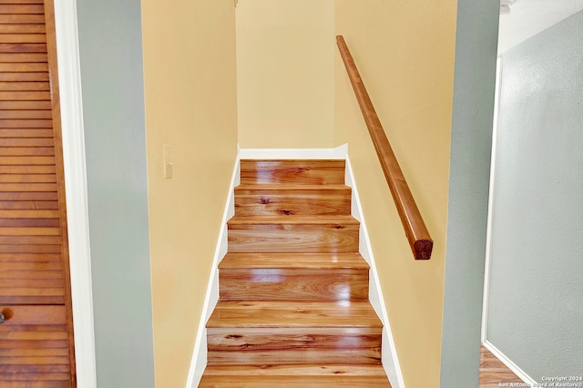 stairway featuring hardwood / wood-style flooring