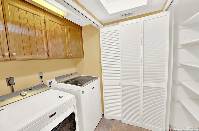 washroom featuring cabinets and washing machine and dryer