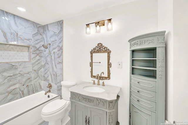 full bathroom featuring toilet, vanity, and tiled shower / bath combo