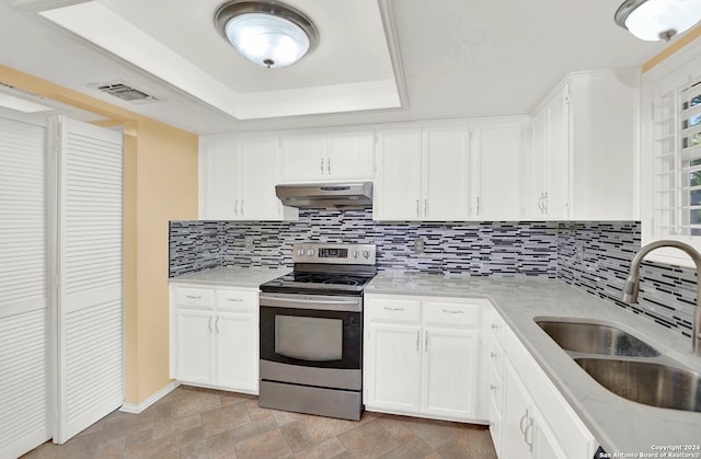 kitchen featuring sink, white cabinets, a raised ceiling, and stainless steel range with electric stovetop