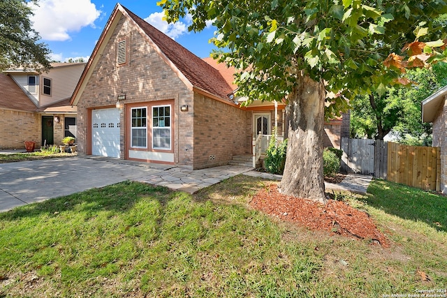 view of front of house with a garage and a front lawn