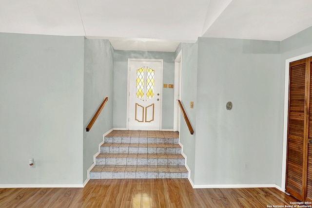 stairs featuring wood-type flooring