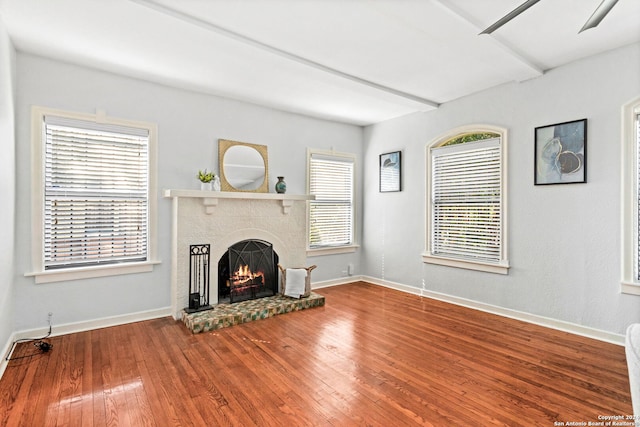 unfurnished living room featuring a fireplace, hardwood / wood-style floors, and ceiling fan