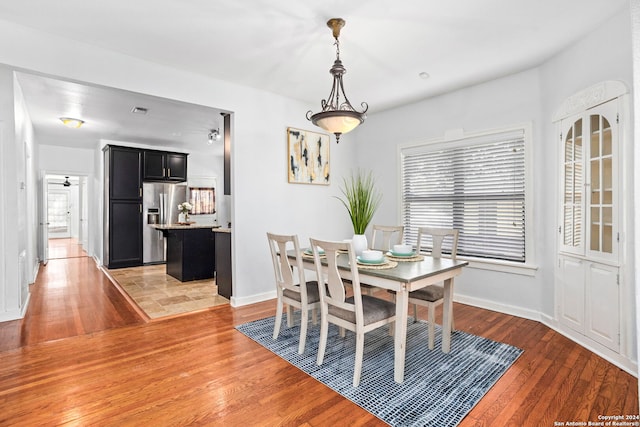 dining room with plenty of natural light, light hardwood / wood-style flooring, and ceiling fan