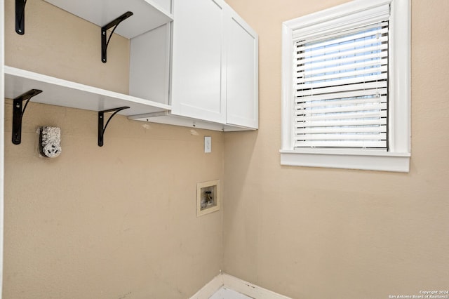 laundry area featuring hookup for a washing machine and cabinets