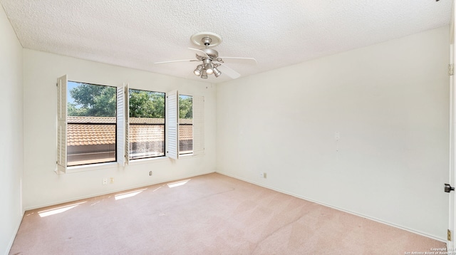 carpeted empty room with a textured ceiling and ceiling fan