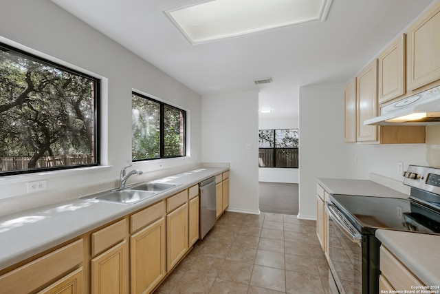 kitchen with light tile patterned floors, light brown cabinetry, stainless steel appliances, and sink