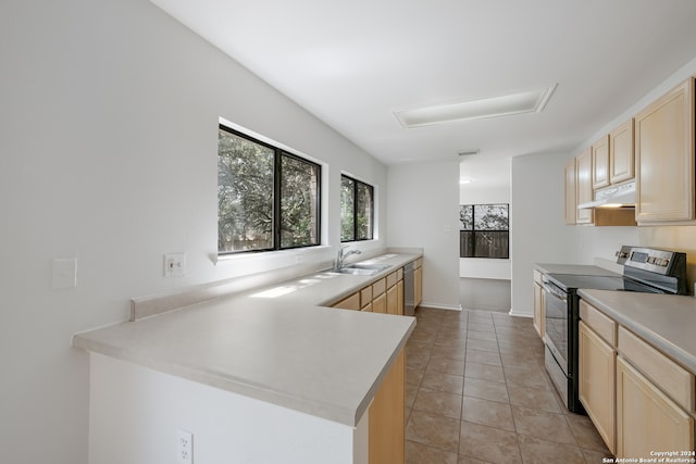 kitchen featuring light brown cabinetry, stainless steel appliances, sink, kitchen peninsula, and light tile patterned flooring