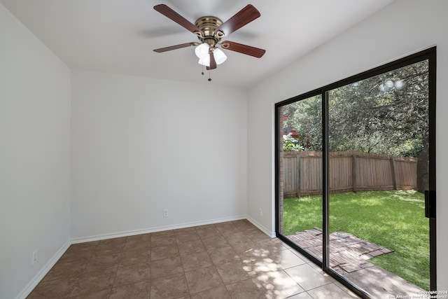 tiled empty room featuring ceiling fan