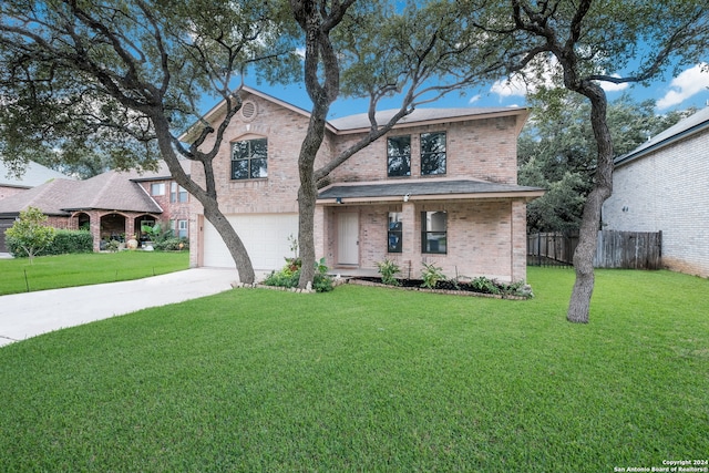 view of front of house with a garage and a front lawn