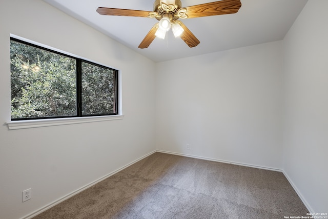 carpeted spare room with ceiling fan