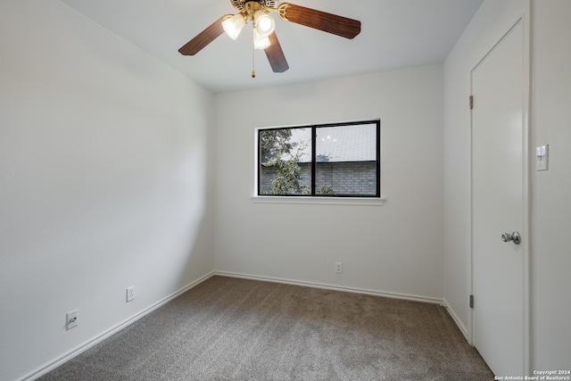 spare room featuring carpet flooring and ceiling fan