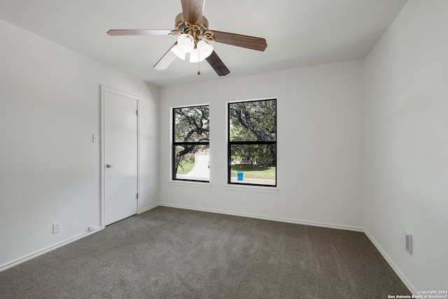 carpeted spare room featuring ceiling fan