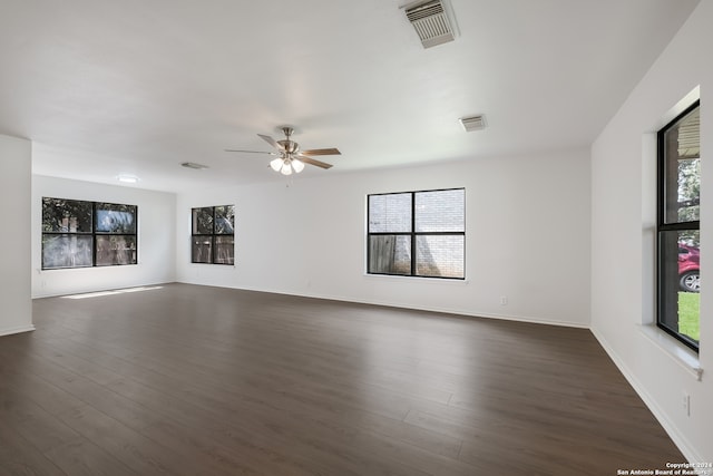 unfurnished living room with ceiling fan and dark hardwood / wood-style floors