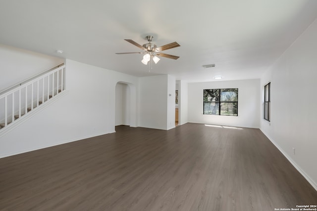 unfurnished living room featuring ceiling fan and dark hardwood / wood-style floors