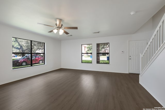 unfurnished living room featuring ceiling fan and dark hardwood / wood-style flooring