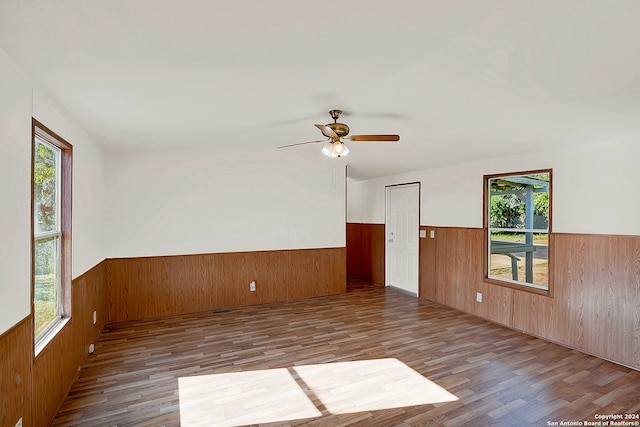 spare room featuring ceiling fan, a wealth of natural light, and hardwood / wood-style flooring