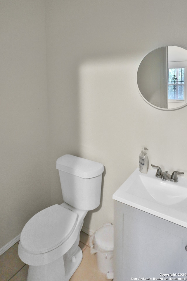 bathroom featuring tile patterned flooring, toilet, and vanity