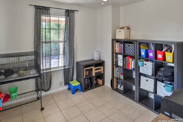 interior space with tile patterned flooring and ceiling fan