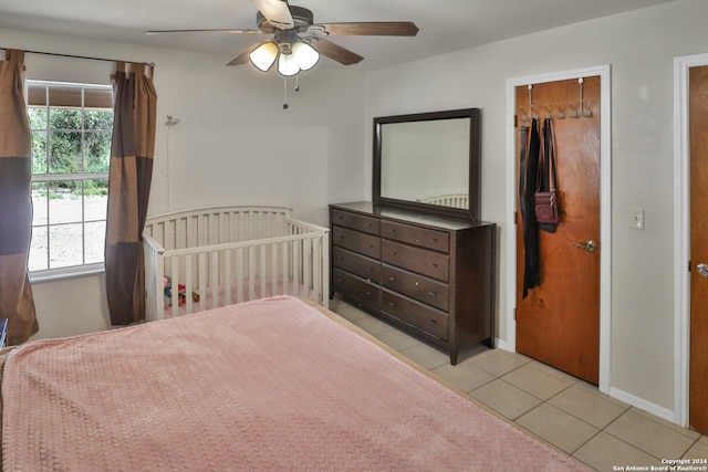 bedroom with light tile patterned floors and ceiling fan