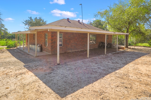 view of side of home with a patio