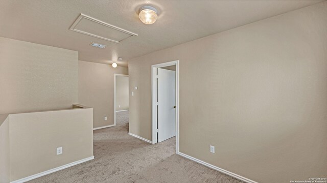 unfurnished room featuring light colored carpet