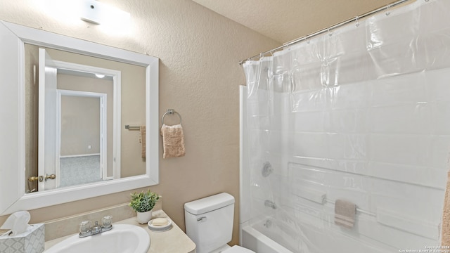 full bathroom with a textured ceiling, toilet, sink, and shower / bathtub combination with curtain