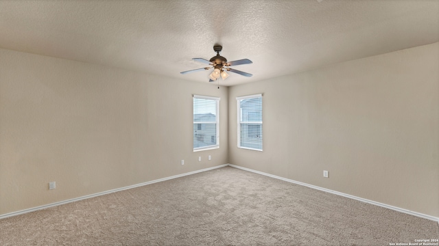 spare room with a textured ceiling, ceiling fan, and carpet floors